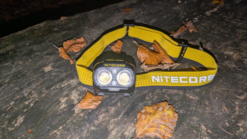 Nitecore UT27 MCT head torch on a log